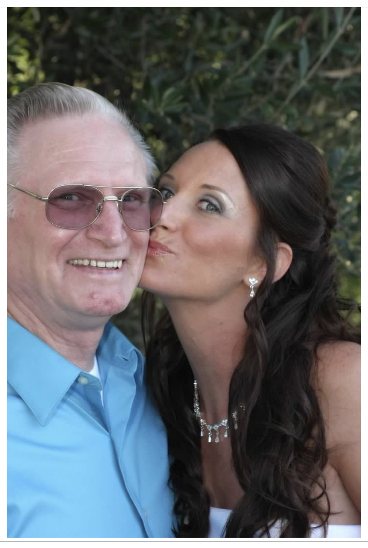 Satin kissing her dad's cheek at her wedding